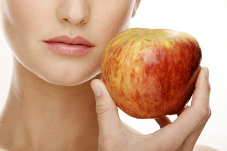 Woman holding apple